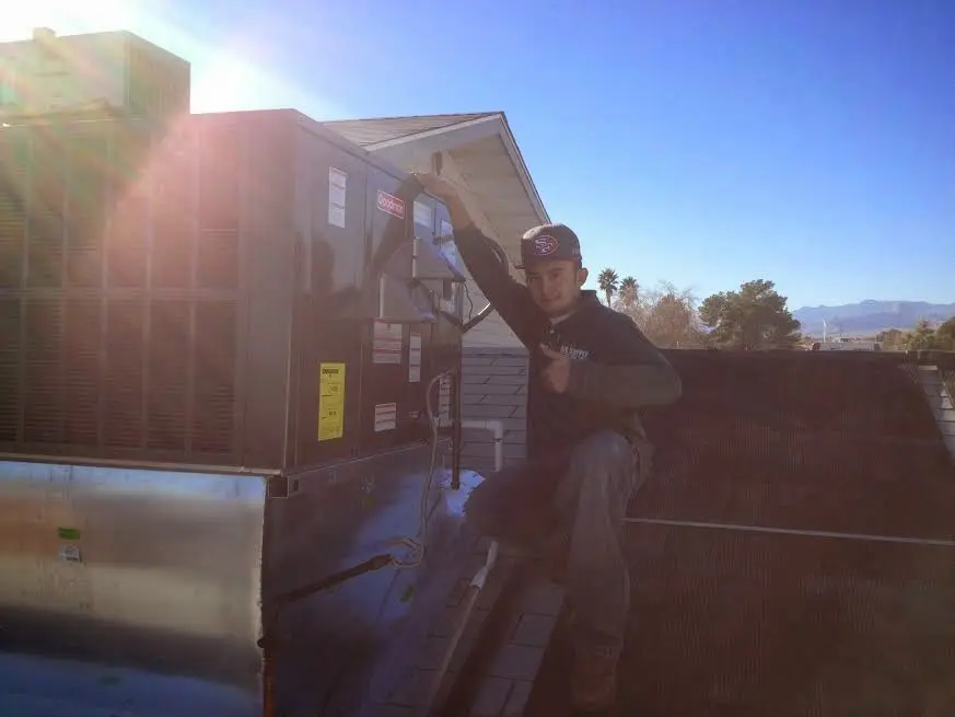HVAC technician performing HVAC Inspection on a rooftop unit in Accokeek